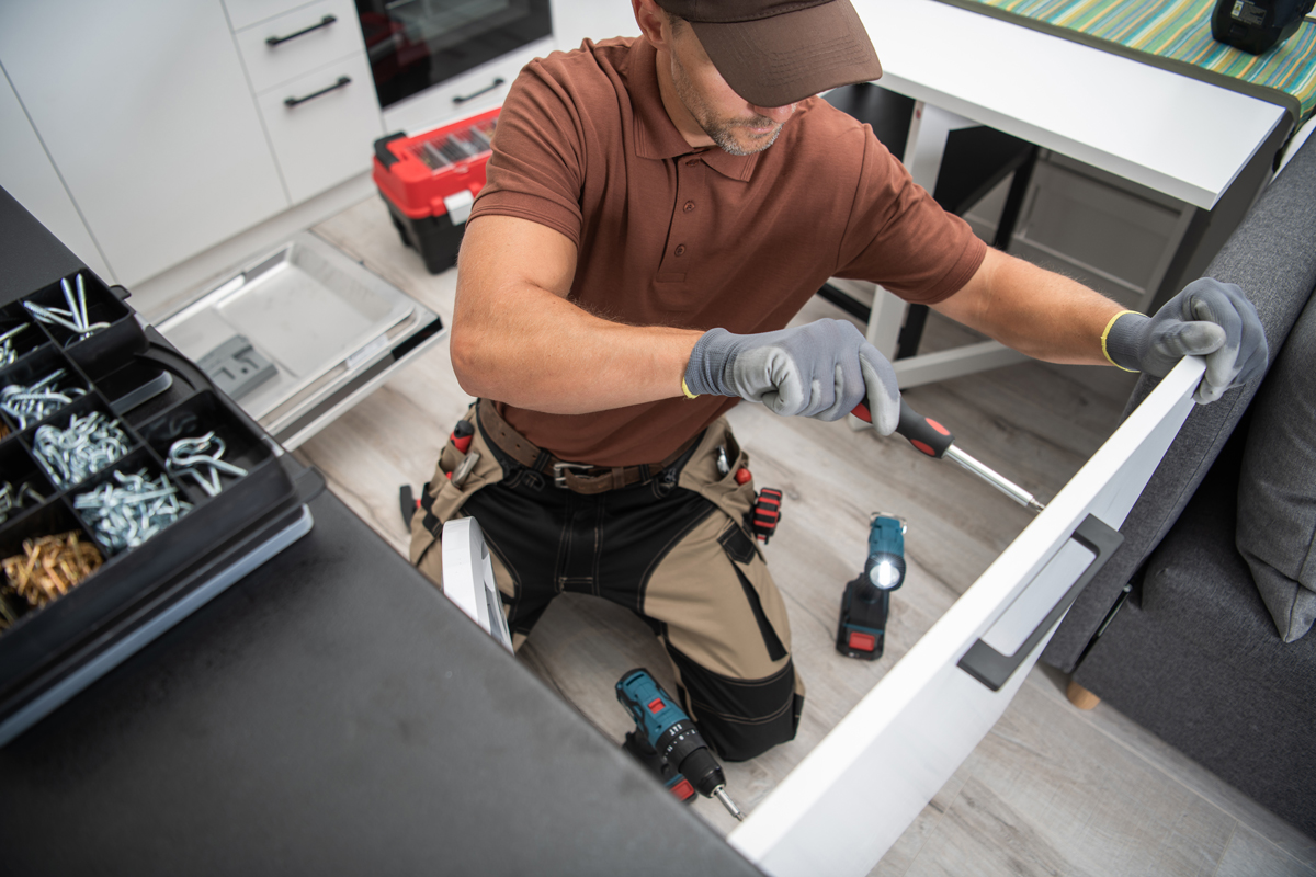 Tradesperson working on a home installation with tools laid out